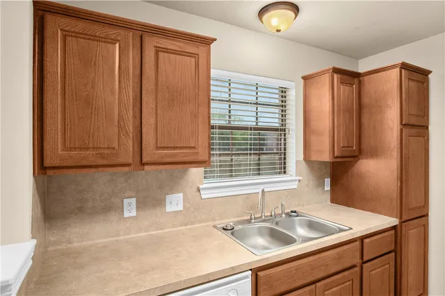a kitchen with stainless steel appliances granite countertop a sink and a window