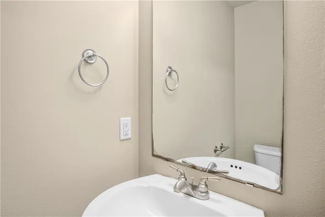 a bathroom with a sink vanity and toilet