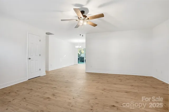 a view of an empty room with window and fireplace
