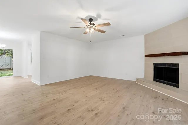 a living room with a fireplace and a rug