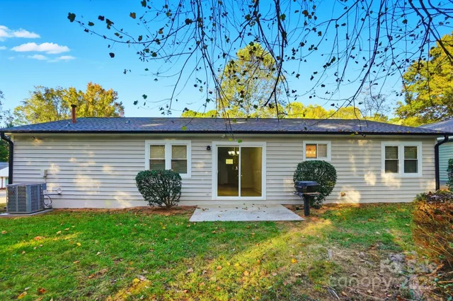 a view of a house with a yard and sitting area