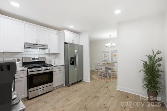 a view of a room with wooden floor and furniture