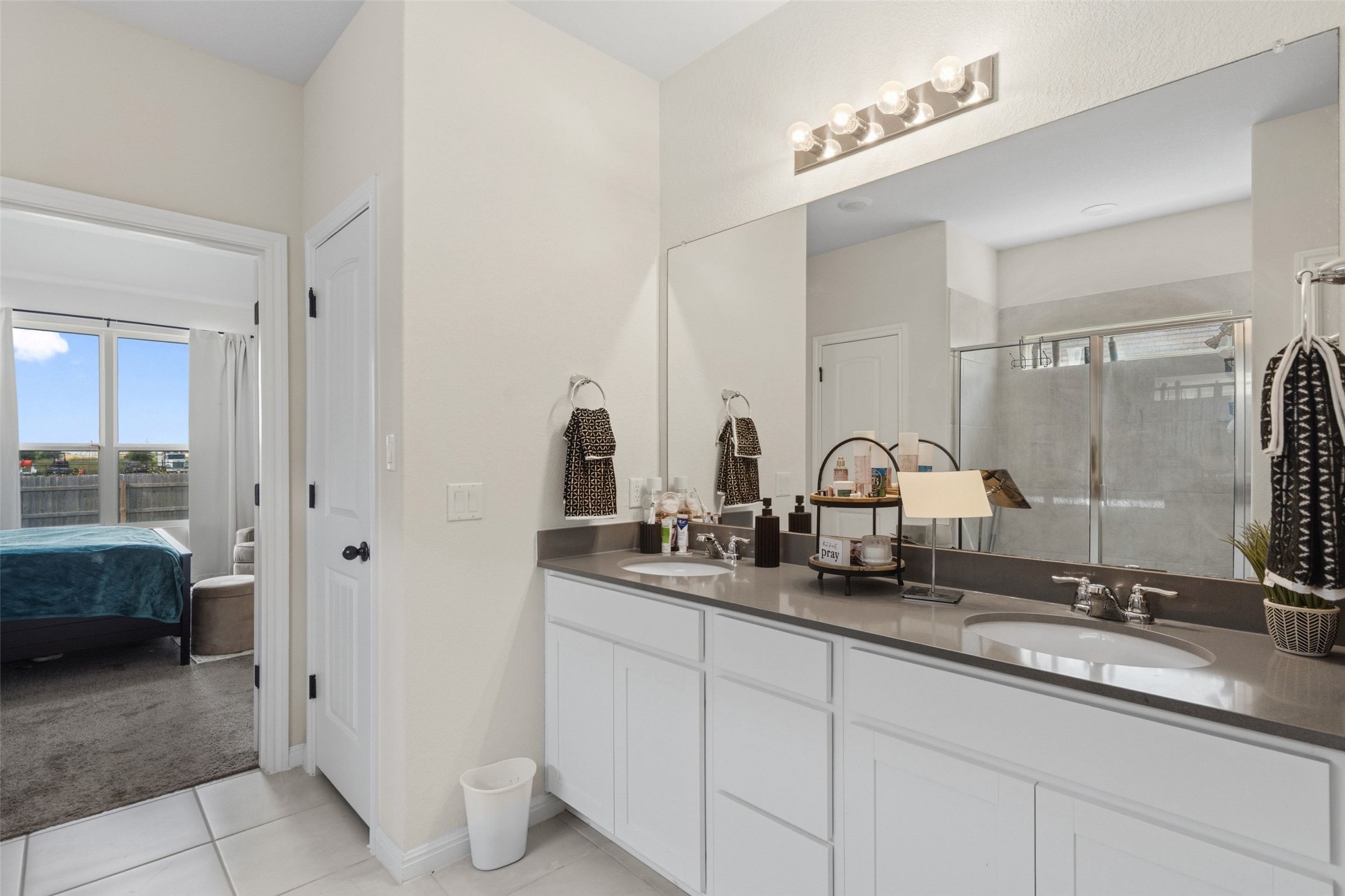 100 Panico Road Hutto, TX 78634 - Photo 20 of 28 A contemporary vanity with double sinks and elegant countertops elevates daily routines.