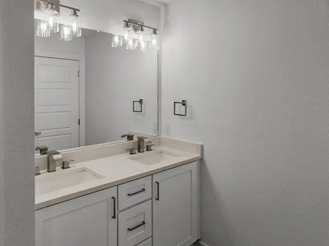 a bathroom with a sink vanity and a mirror