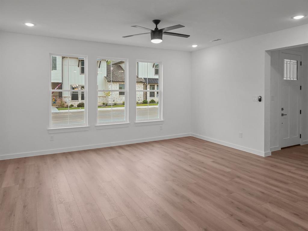 9565 Thorncrown Lane Fort Worth, TX 76179 - Photo 7 of 25 an empty room with wooden floor and windows