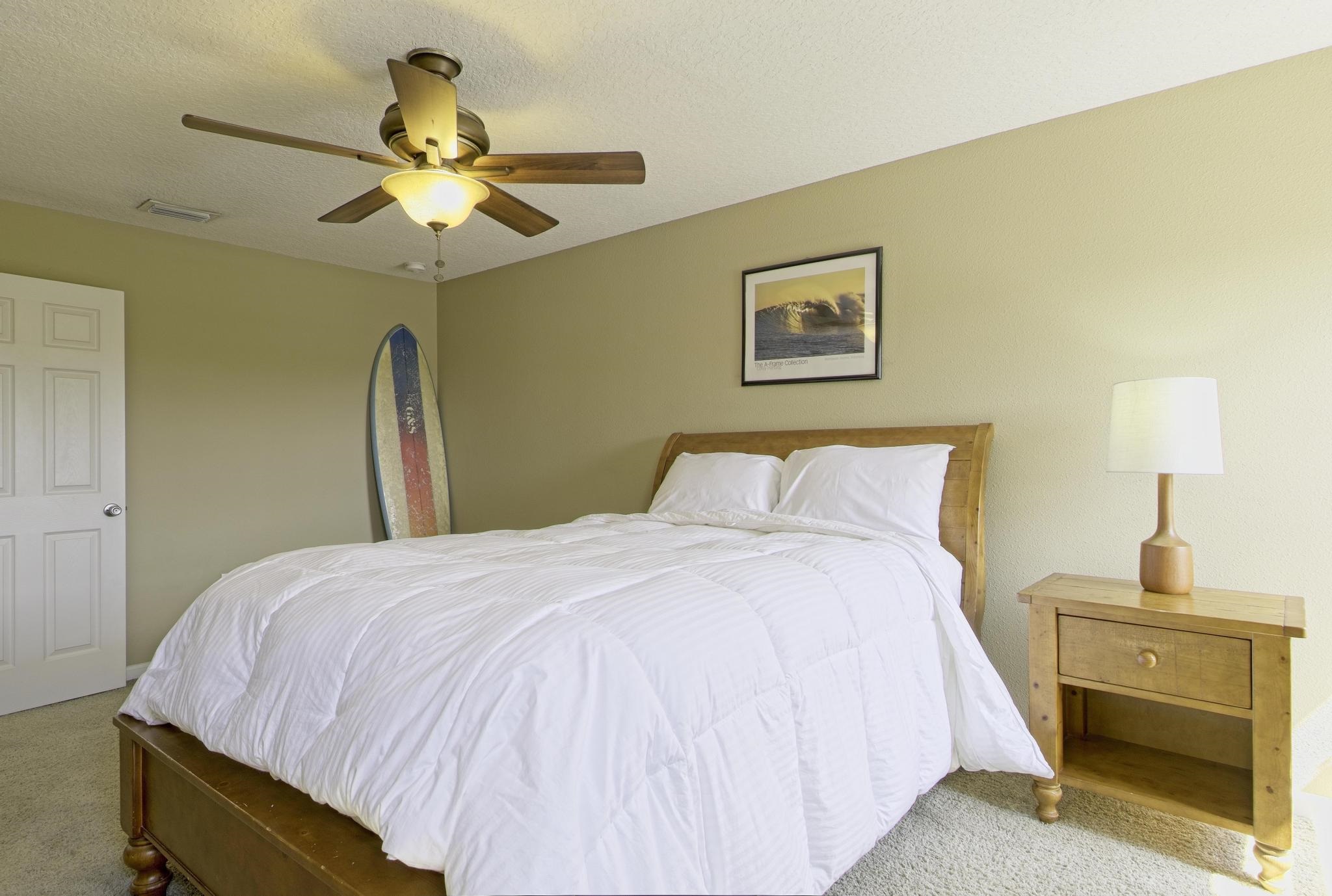 167 Islander Drive St. Augustine, FL 32080 - Photo 13 of 34 a bedroom with a bed and a chandelier