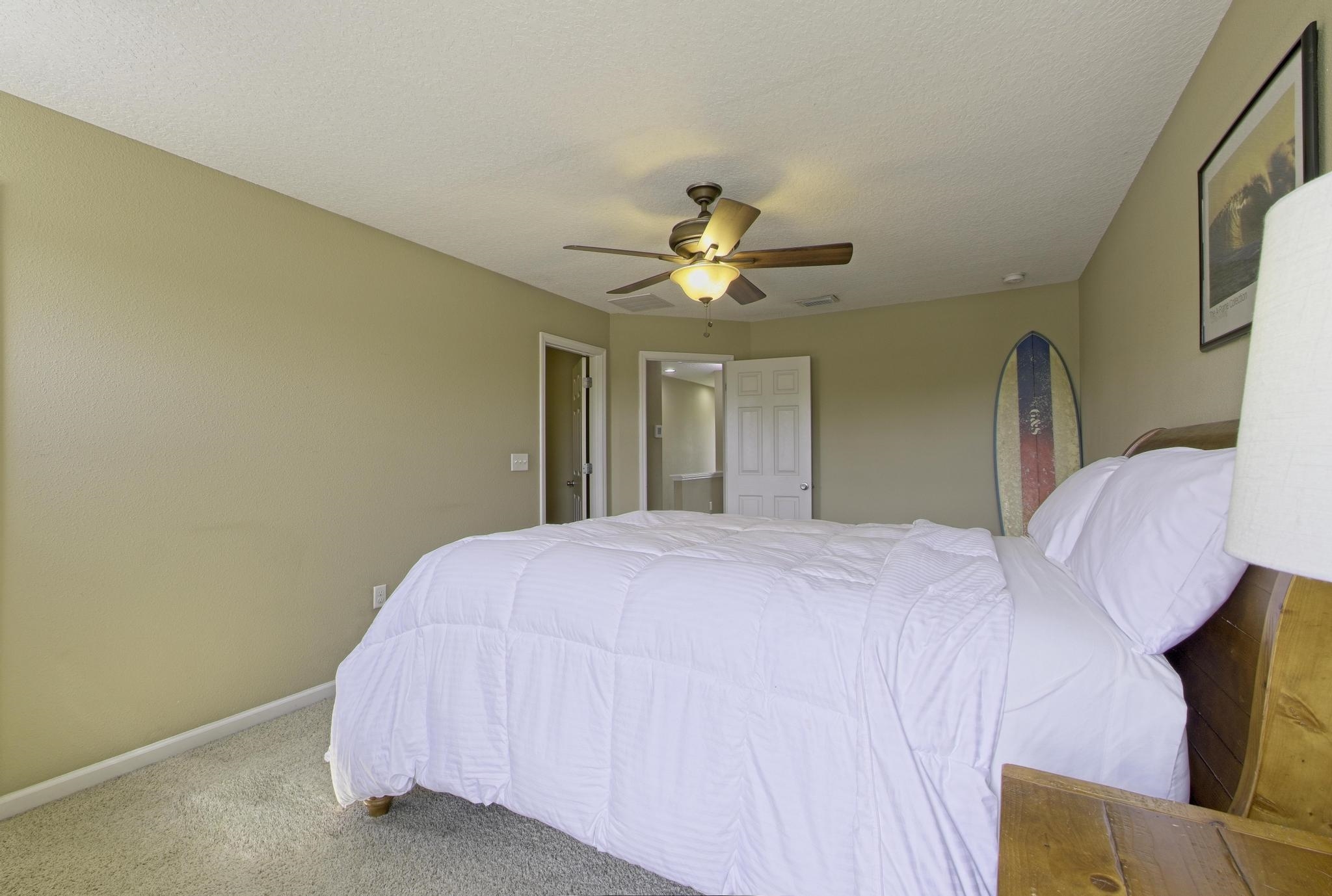 167 Islander Drive St. Augustine, FL 32080 - Photo 14 of 34 a bedroom with a bed and a chandelier