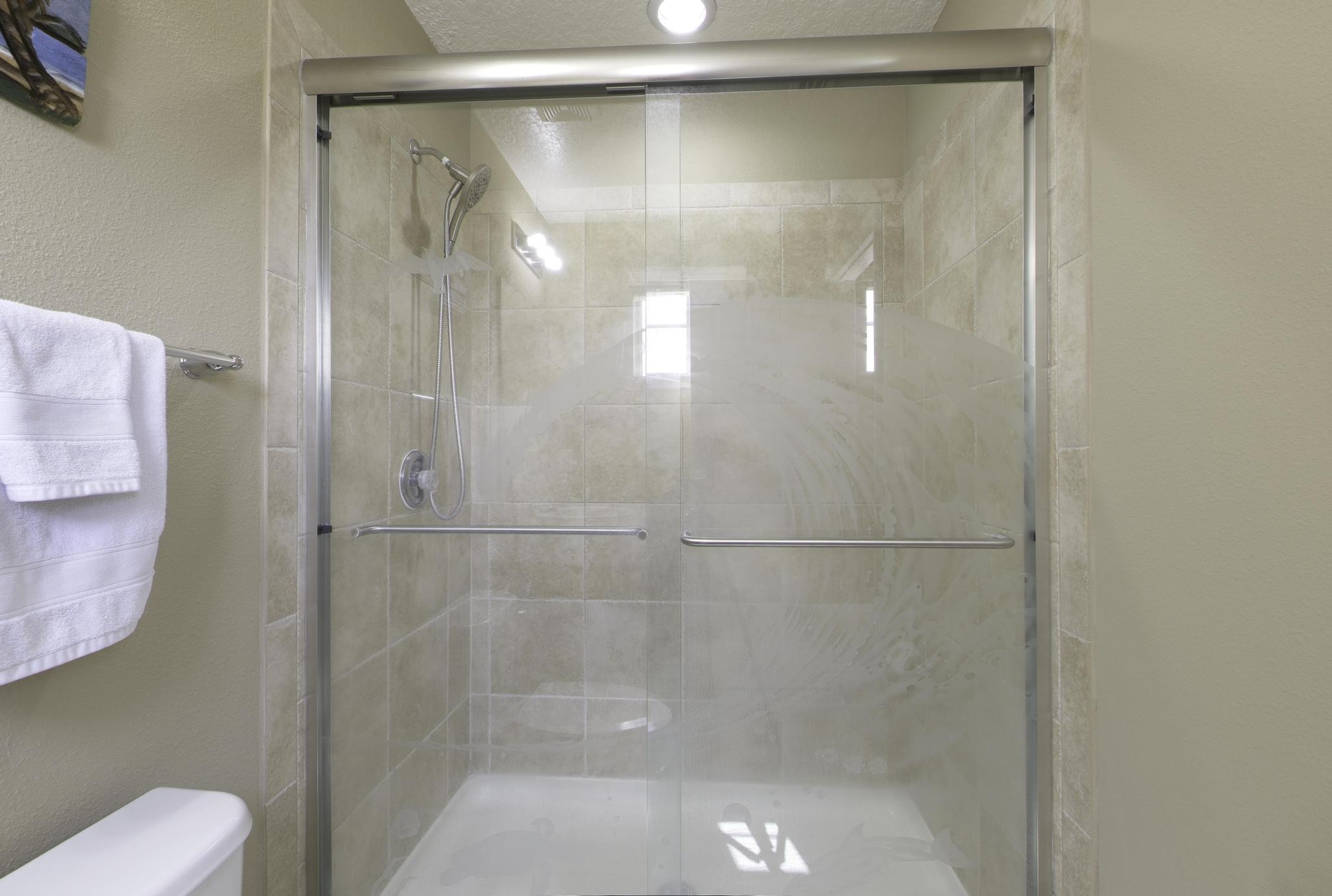 167 Islander Drive St. Augustine, FL 32080 - Photo 16 of 34 a bathroom with a glass shower door