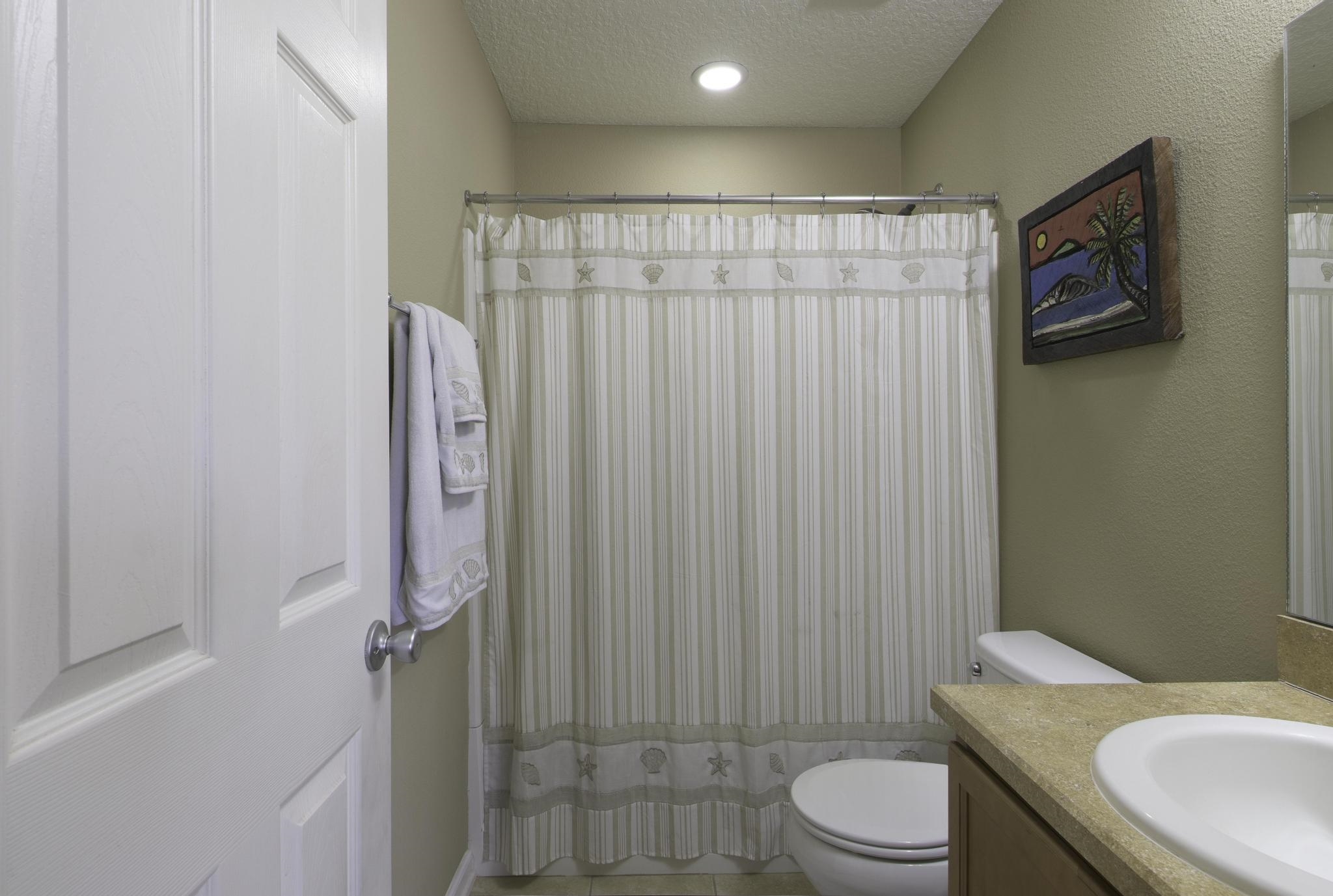 167 Islander Drive St. Augustine, FL 32080 - Photo 20 of 34 a bathroom with a sink a toilet and shower curtain
