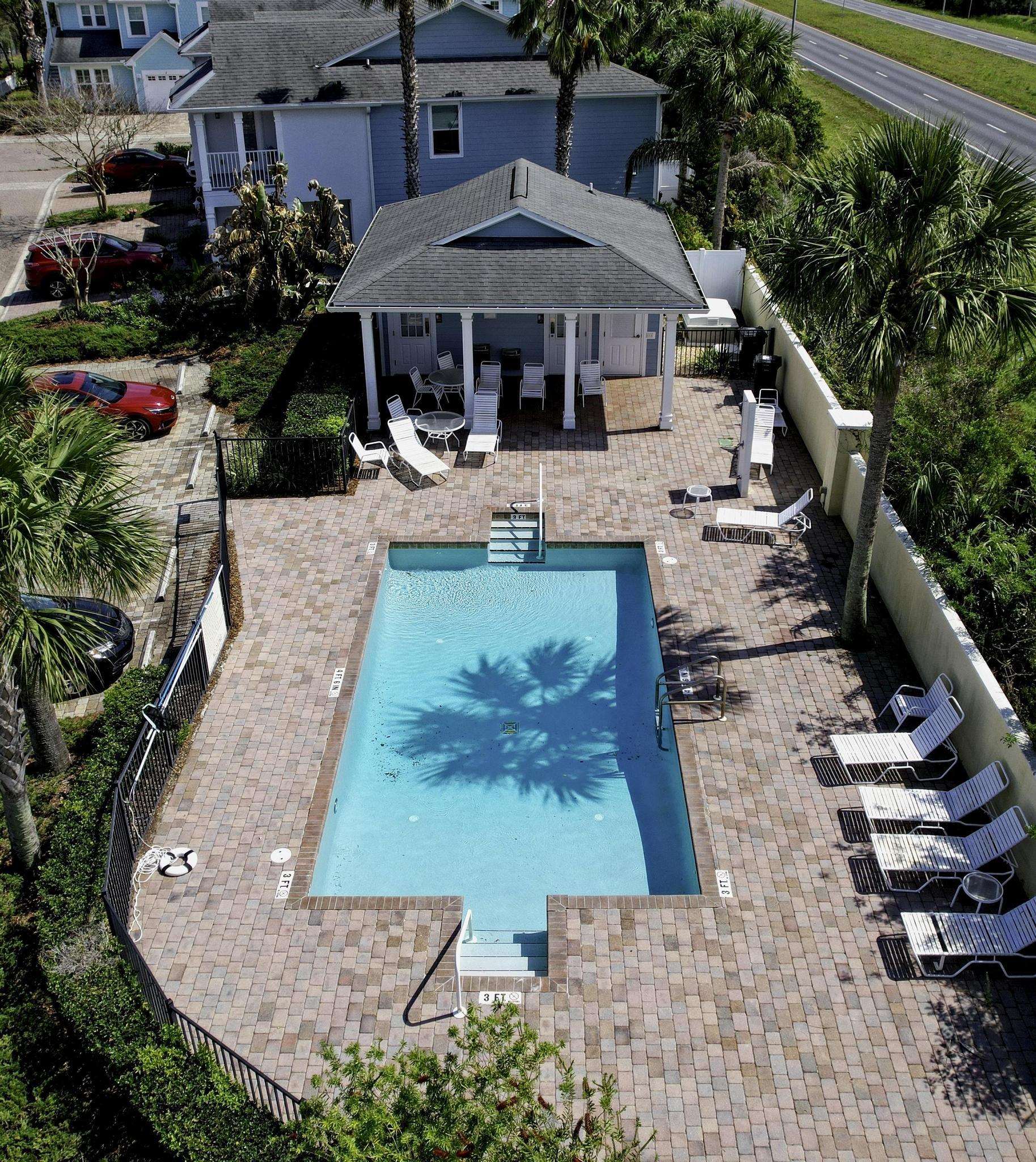 167 Islander Drive St. Augustine, FL 32080 - Photo 30 of 34 a view of a patio with table and chairs potted plants
