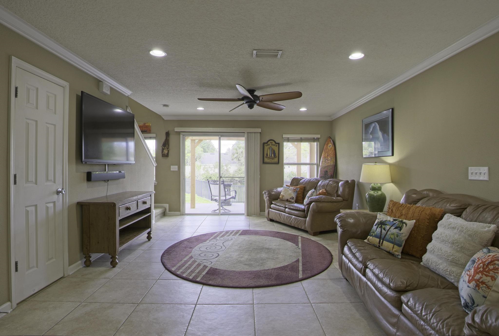 167 Islander Drive St. Augustine, FL 32080 - Photo 5 of 34 a living room with furniture a flat screen tv and kitchen view