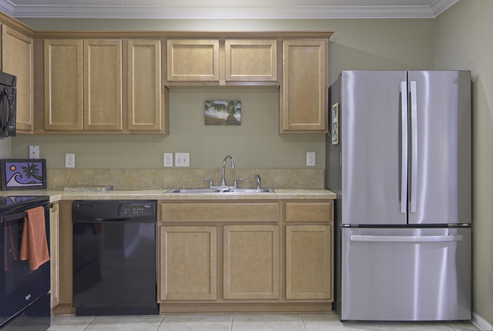167 Islander Drive St. Augustine, FL 32080 - Photo 9 of 34 a kitchen with a refrigerator sink and cabinets