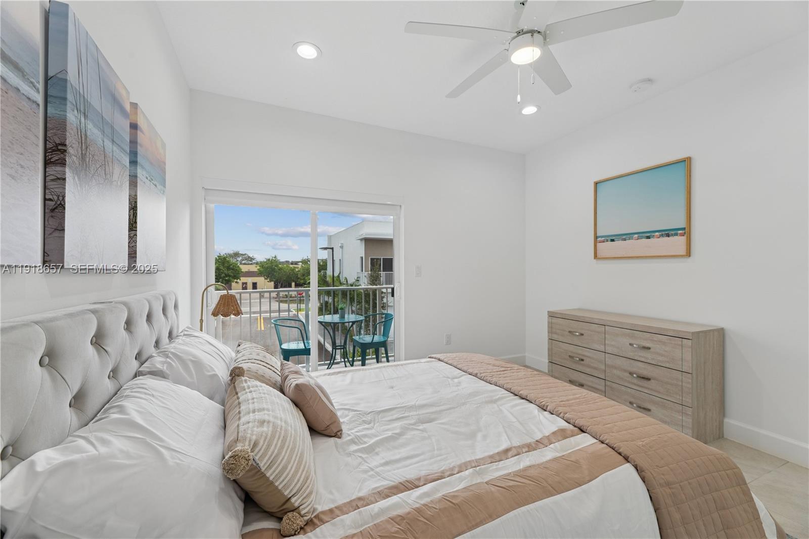 355 Northwest 30th Avenue, Unit 1311 Pompano Beach, FL 33069 - Photo 13 of 19 a bedroom with a large bed and a chandelier