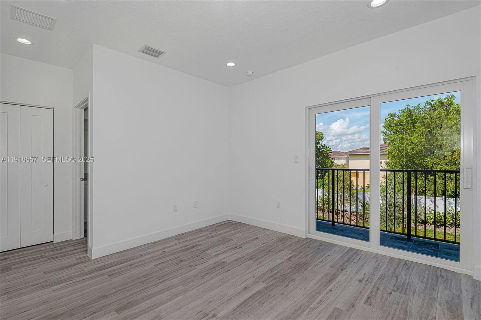 355 Northwest 30th Avenue, Unit 1311 Pompano Beach, FL 33069 - Photo 6 of 19 wooden floor in an empty room with a window
