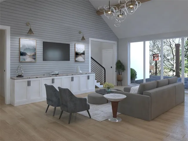 a living room with furniture a large window and a flat screen tv