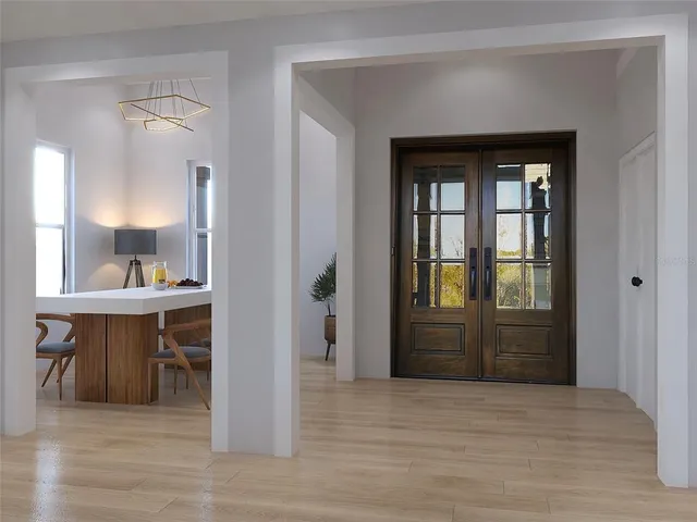 a view of kitchen and hall with wooden floor