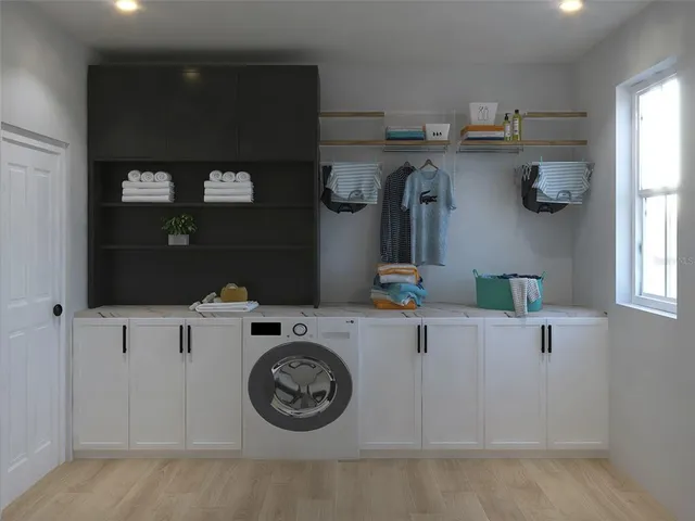 a utility room with sink dryer and washer