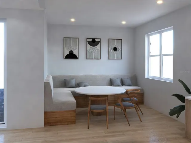 a view of a dining room with furniture and a window