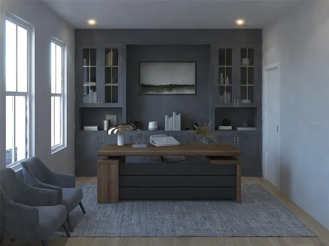 a room with a couch cabinets and window