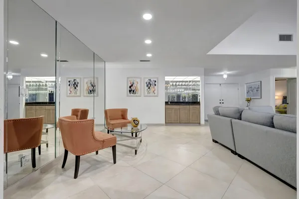 a living room with furniture and kitchen view
