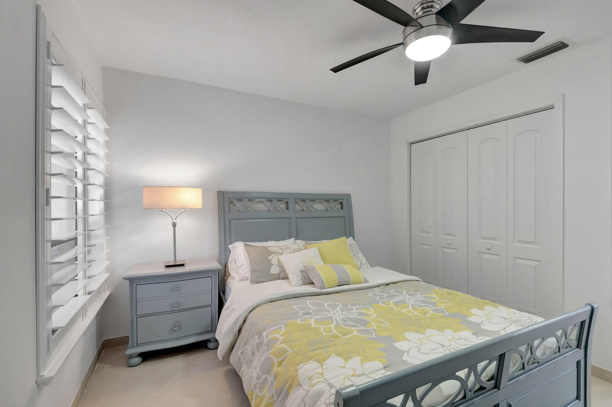 902 Foxpointe Circle Delray Beach, FL 33445 - Photo 24 of 43 a bedroom with a bed and a chandelier