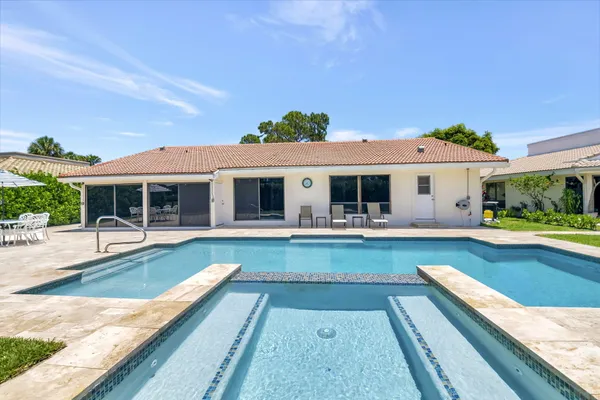 a view of a house with swimming pool and a porch