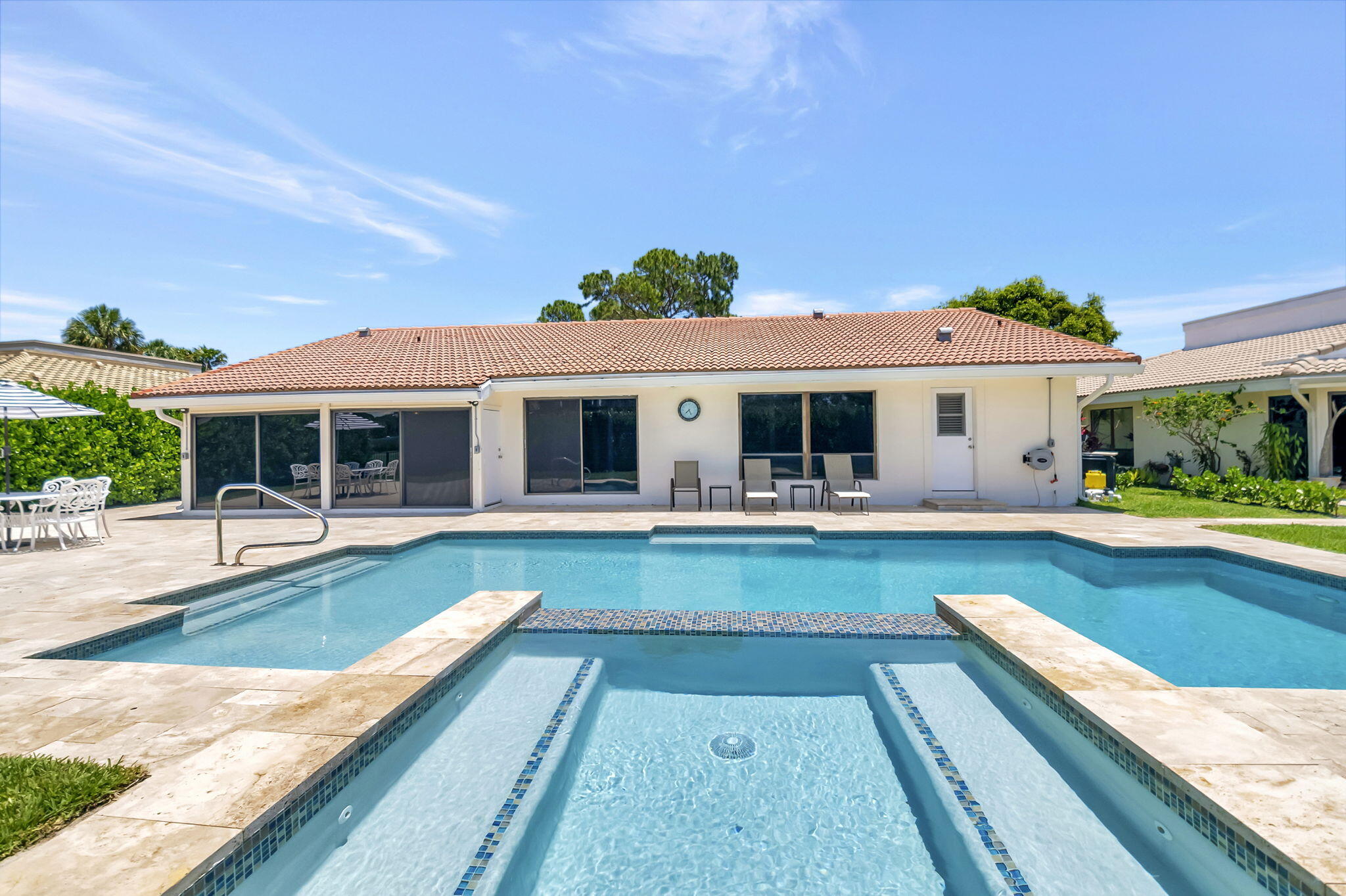 902 Foxpointe Circle Delray Beach, FL 33445 - Photo 40 of 43 a view of a house with swimming pool and a porch