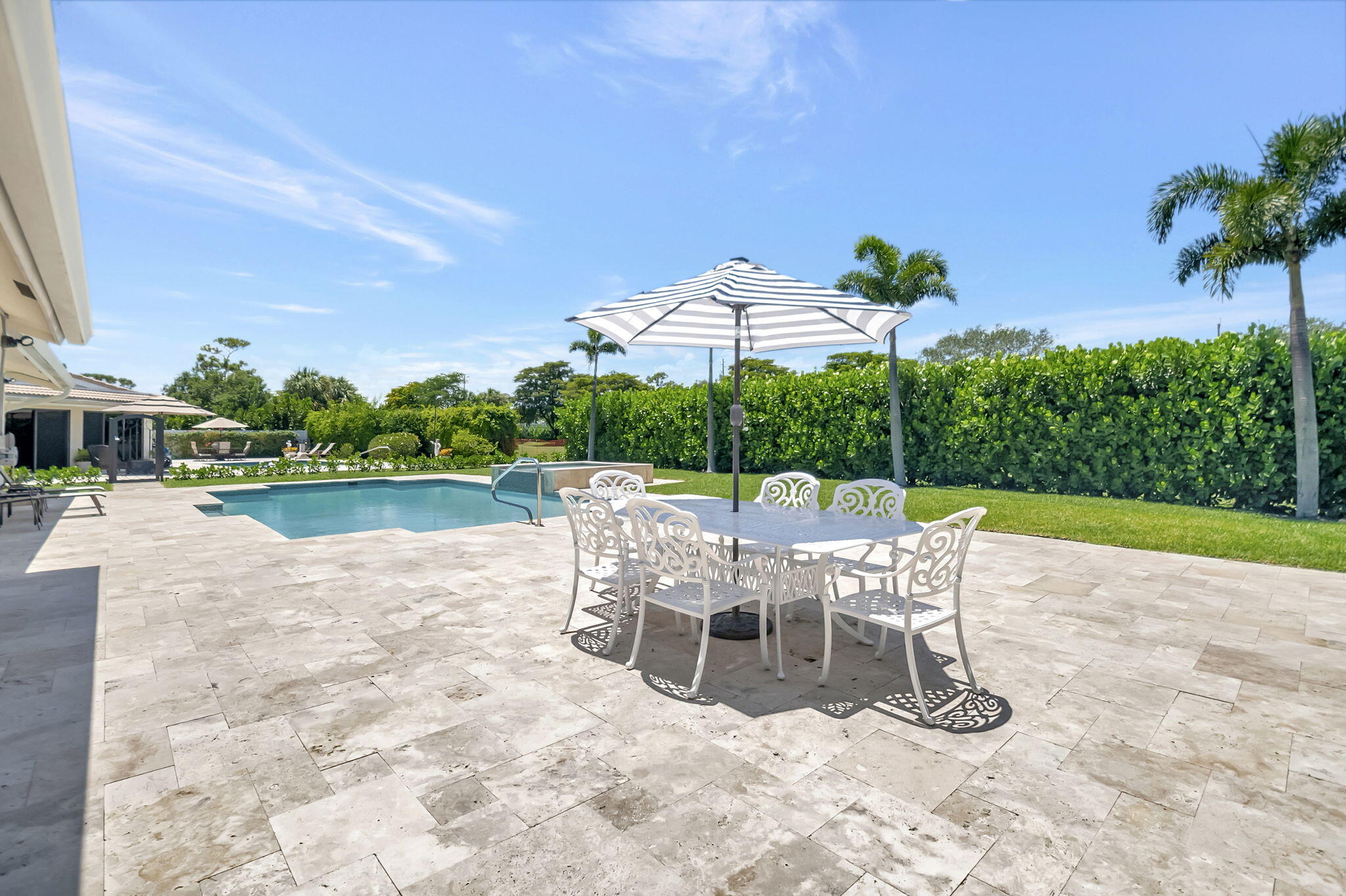 902 Foxpointe Circle Delray Beach, FL 33445 - Photo 42 of 43 a view of a patio with a table and chairs under an umbrella