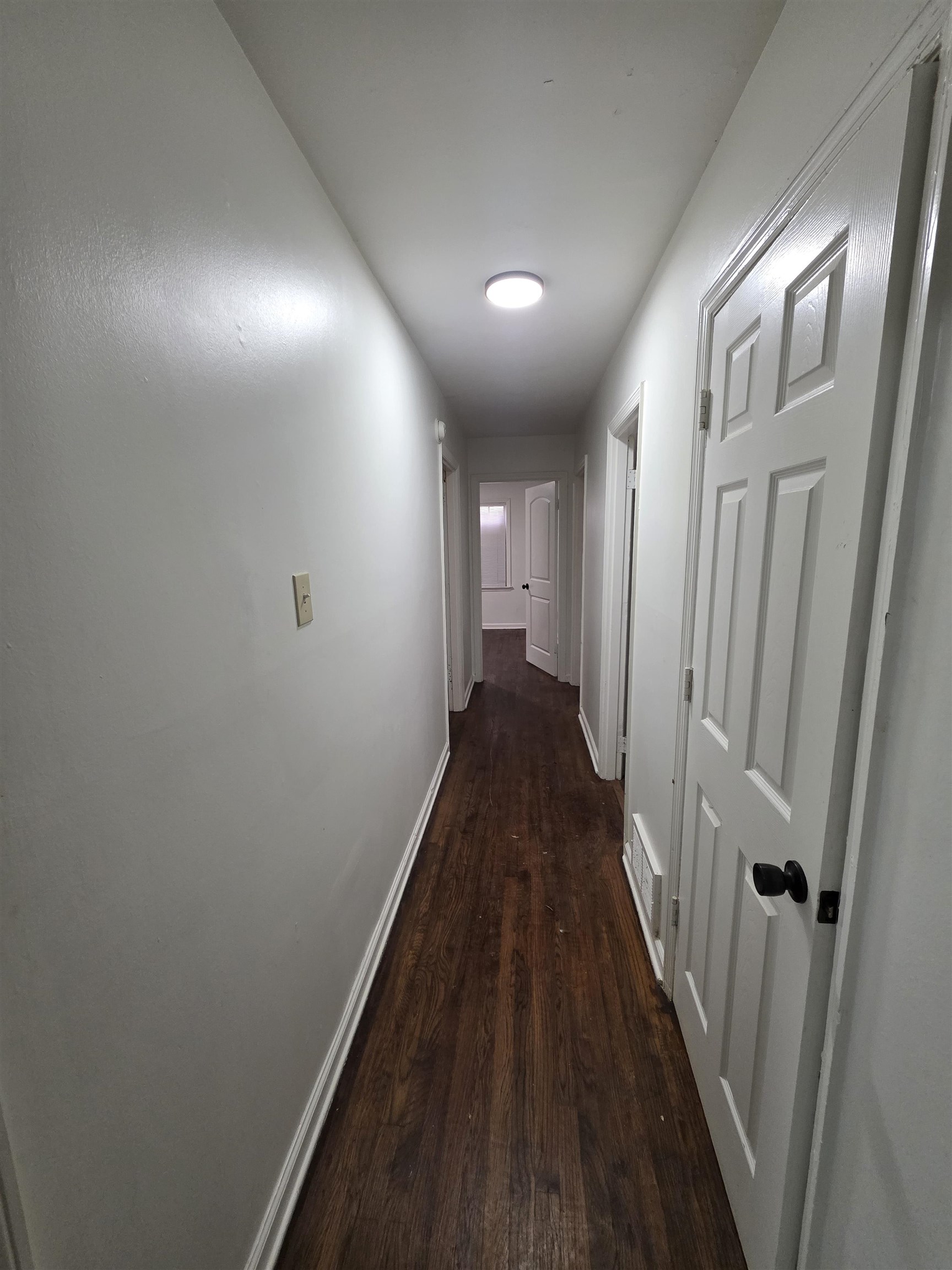 3764 Cazassa Road Memphis, TN 38116 - Photo 9 of 16 Hallway featuring wood-finish flooring, white baseboards, and a flush-mount ceiling light