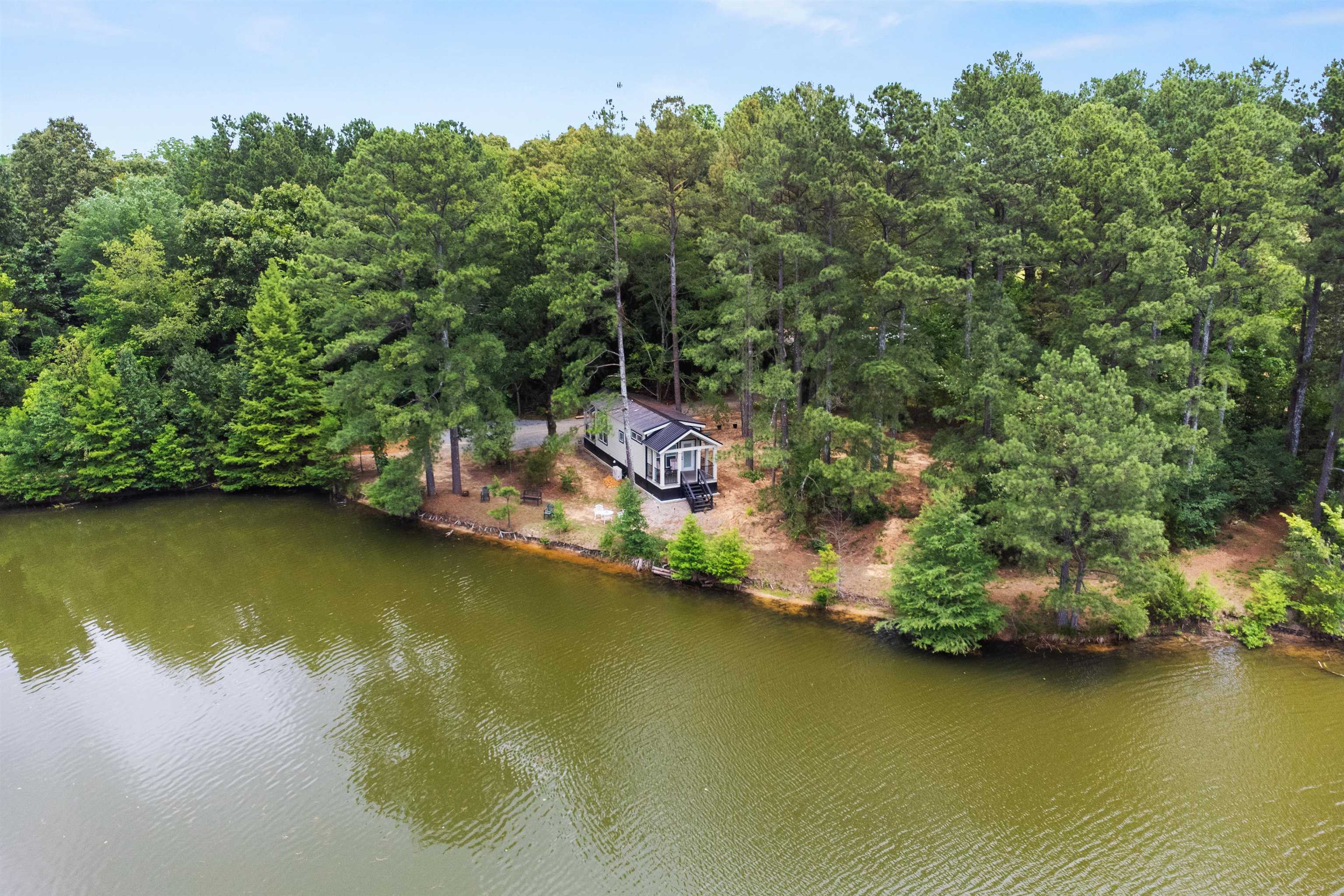 330 Whitley Road Oakland, TN 38060 - Photo 15 of 19 Waterfront property featuring a contemporary structure with a dark-toned exterior, surrounded by mature trees