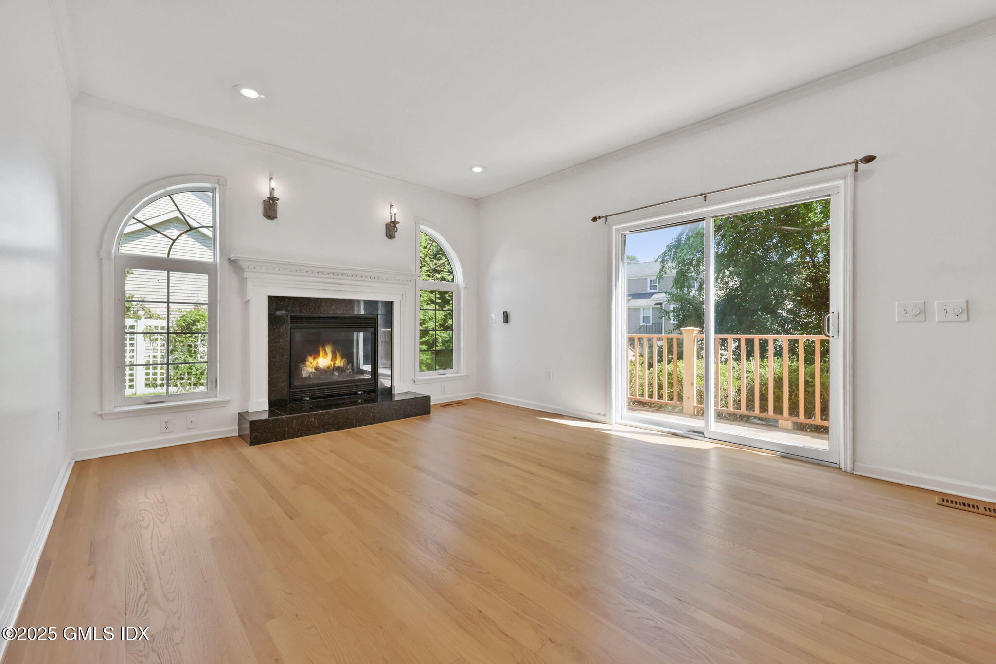 263 Byram Road Greenwich, CT 06830 - Photo 11 of 32 a view of an empty room with a fireplace and a window