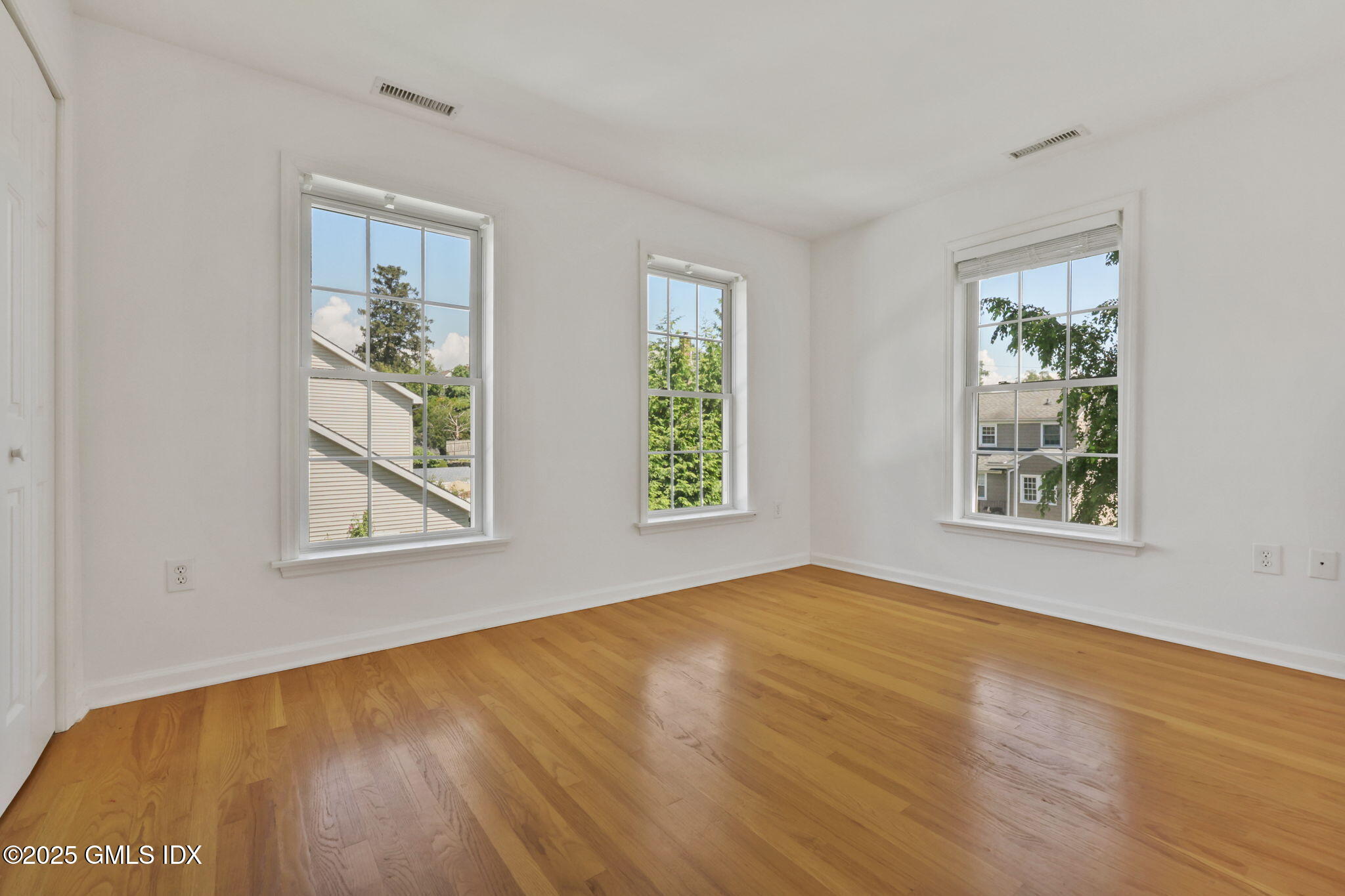 263 Byram Road Greenwich, CT 06830 - Photo 24 of 32 a view of an empty room with wooden floor and a window