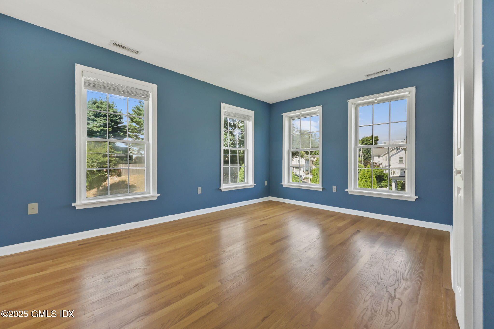 263 Byram Road Greenwich, CT 06830 - Photo 25 of 32 a view of an empty room with window and wooden floor