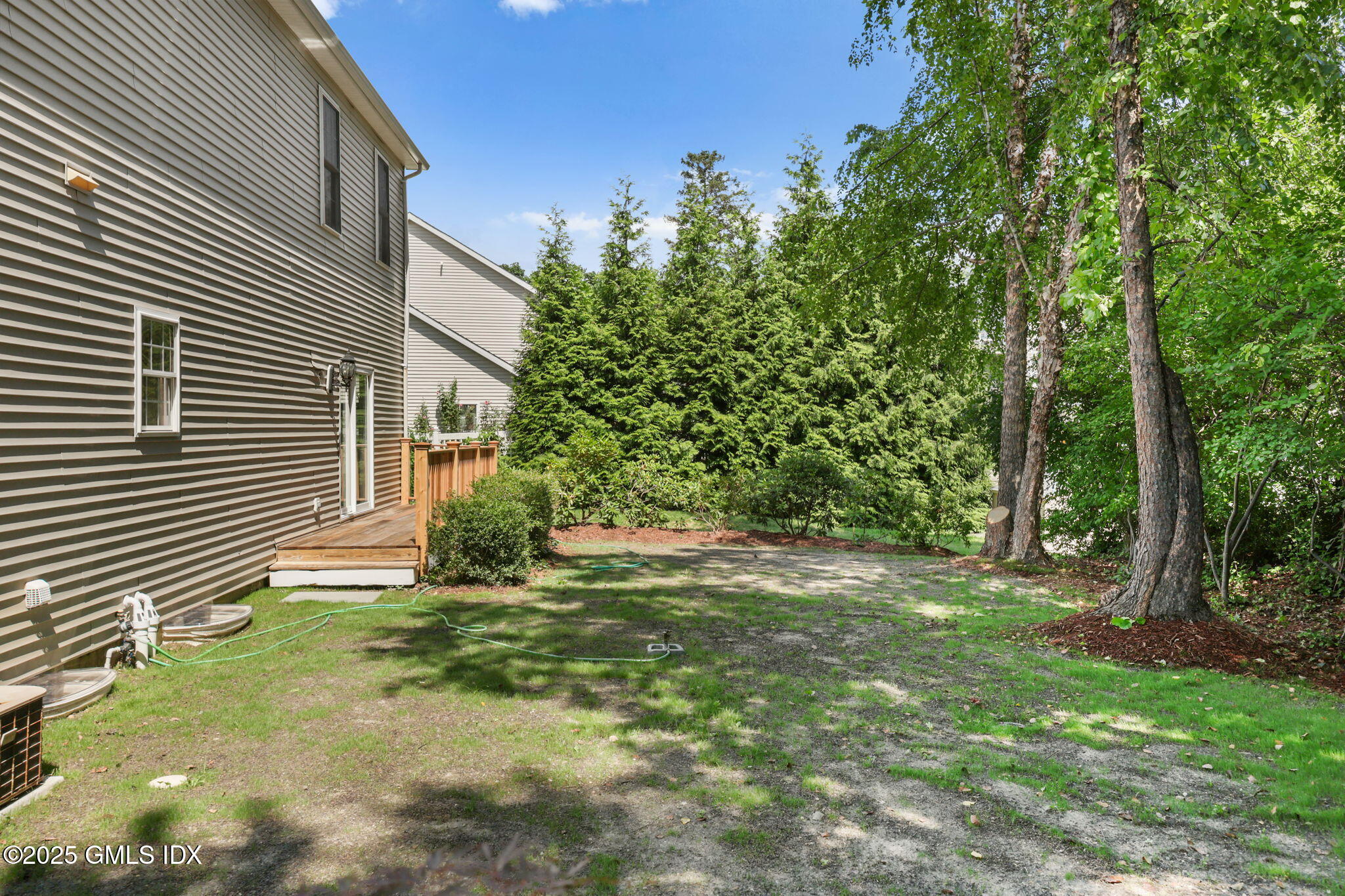 263 Byram Road Greenwich, CT 06830 - Photo 27 of 32 a view of a backyard with plants and large trees