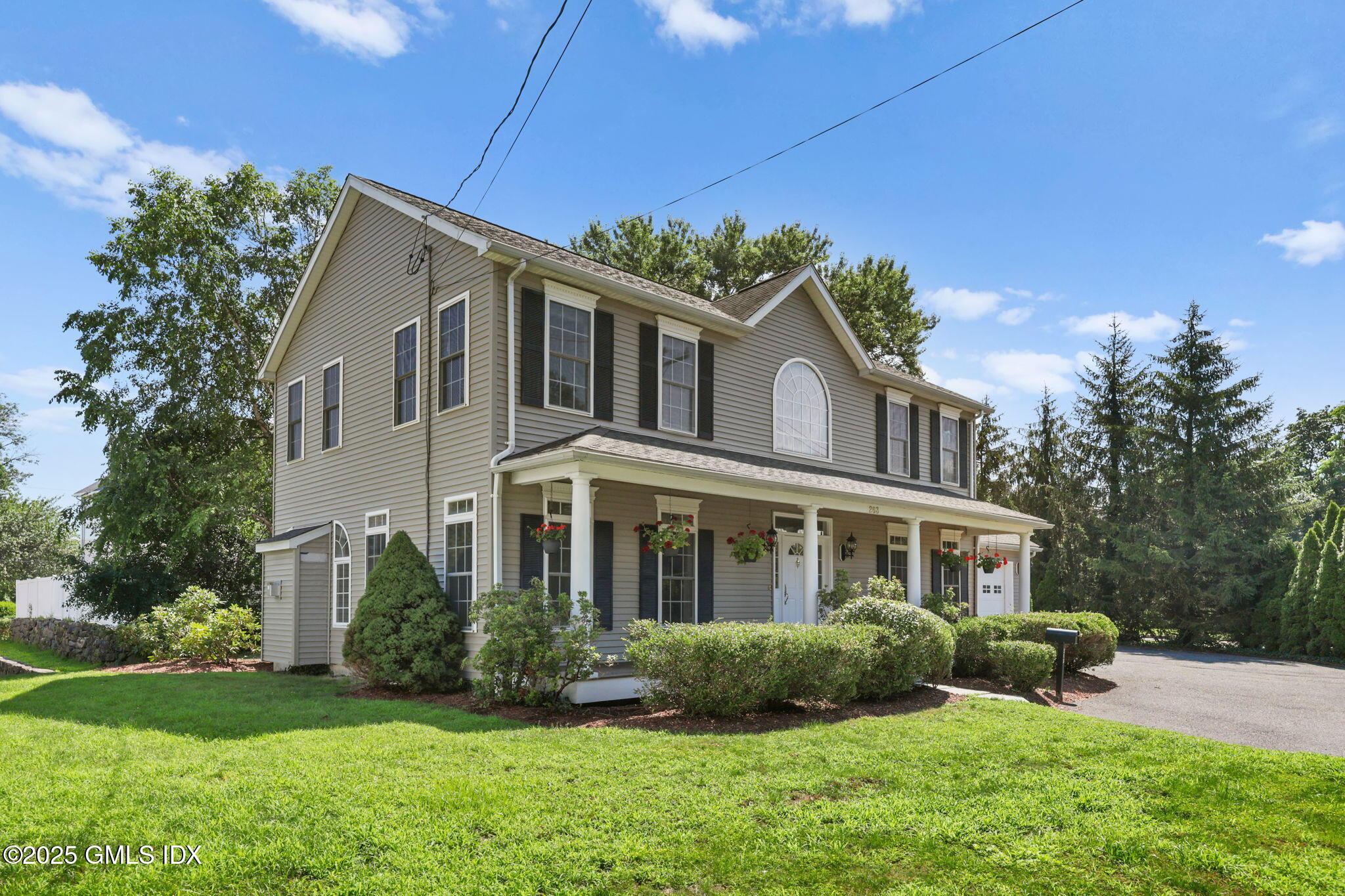 263 Byram Road Greenwich, CT 06830 - Photo 29 of 32 a front view of a house with a yard