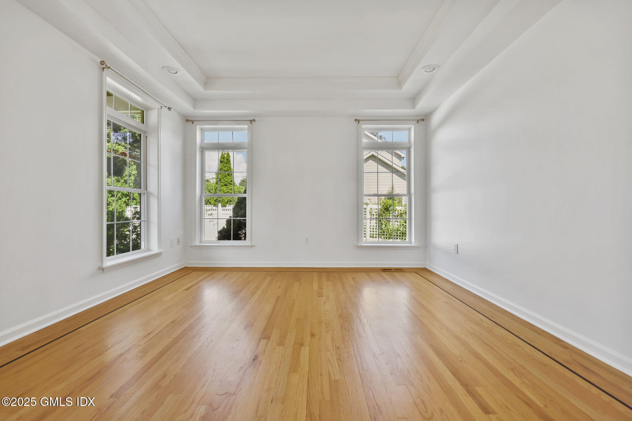 263 Byram Road Greenwich, CT 06830 - Photo 4 of 32 an empty room with wooden floor and windows