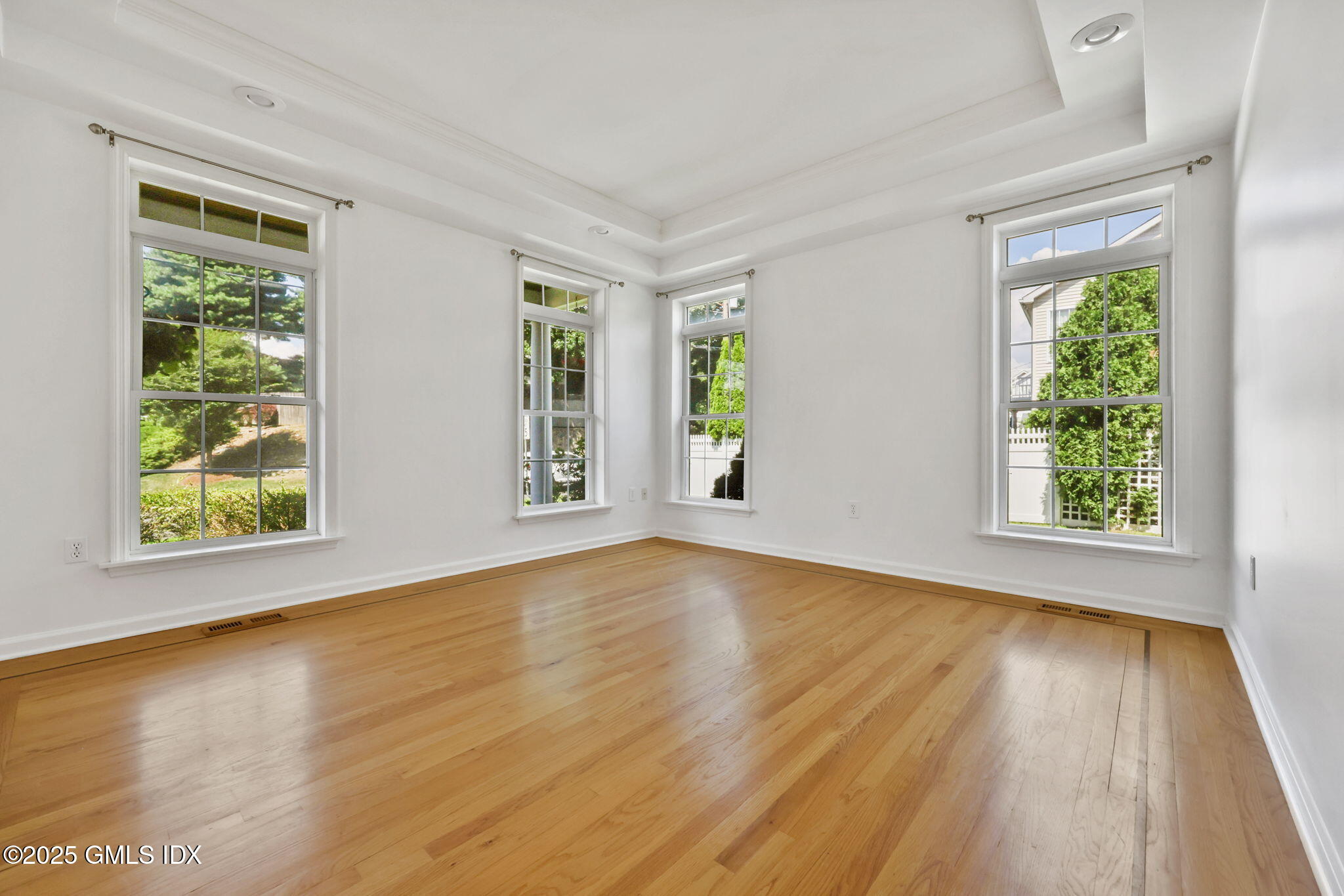 263 Byram Road Greenwich, CT 06830 - Photo 6 of 32 a view of an empty room with wooden floor and a window