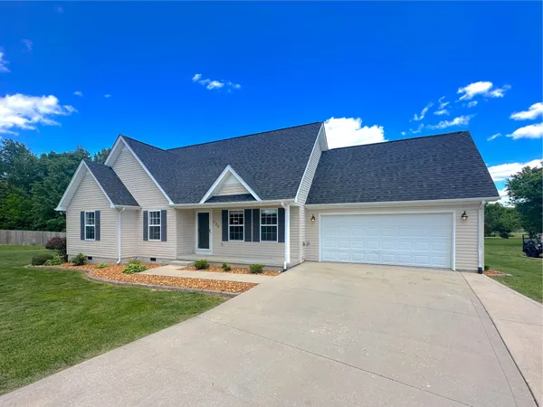 a front view of house with yard and green space