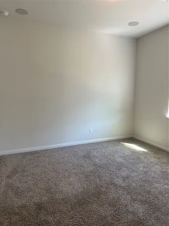 a large kitchen with stainless steel appliances granite countertop a stove a sink a refrigerator a center island and a wooden floor