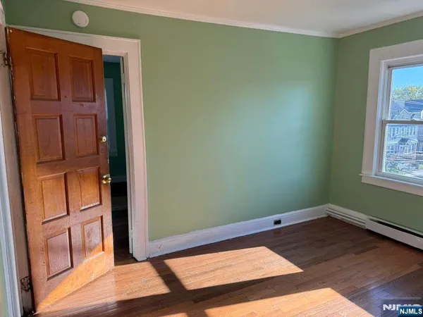 a view of an empty room and wooden floor