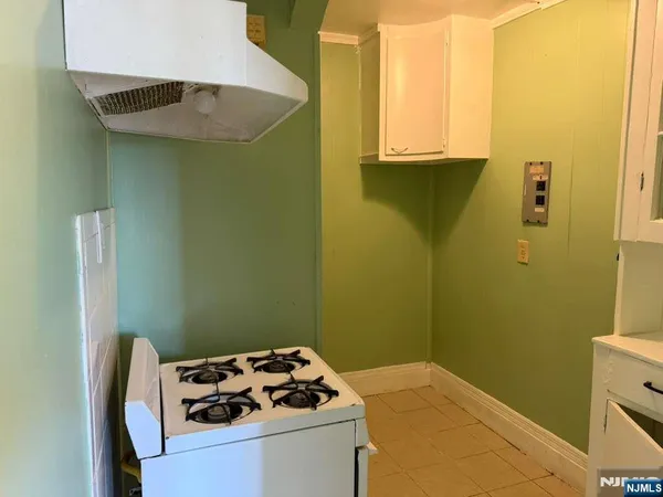 a bedroom with a sink and a stove