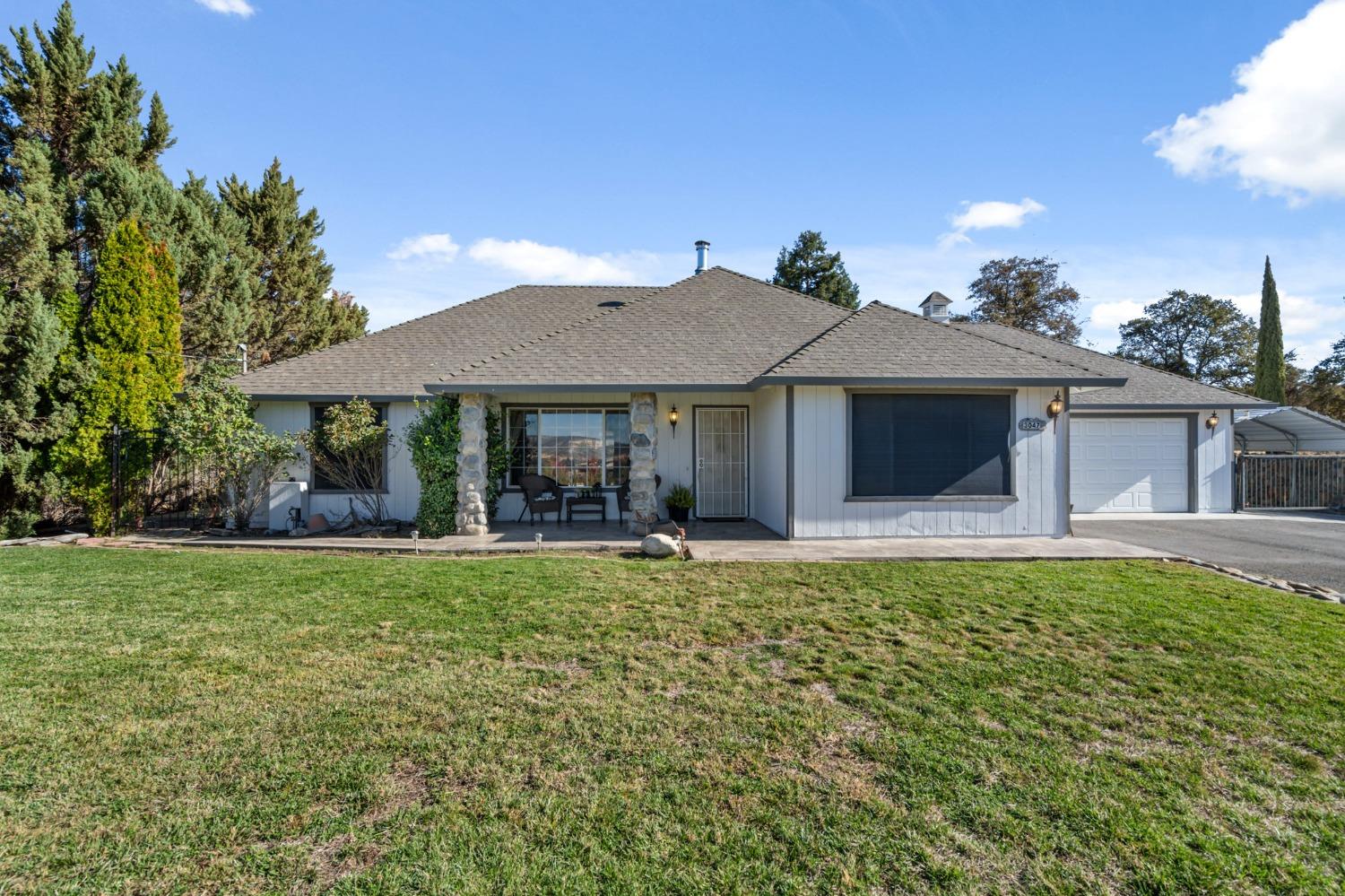 3047 Quail Hill Road Copperopolis, CA 95228 - Photo 1 of 1 a front view of a house with garden