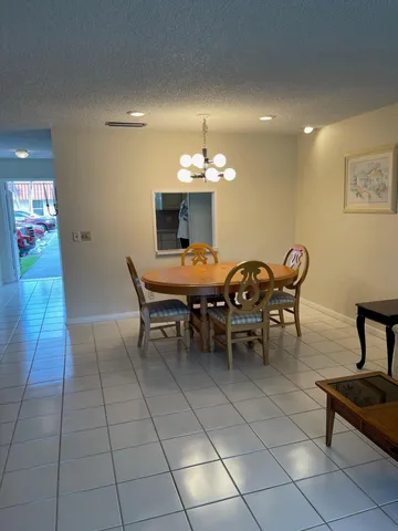 a dining room with furniture and chandelier