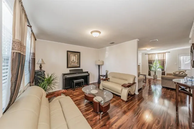 a living room with furniture fireplace and wooden floor