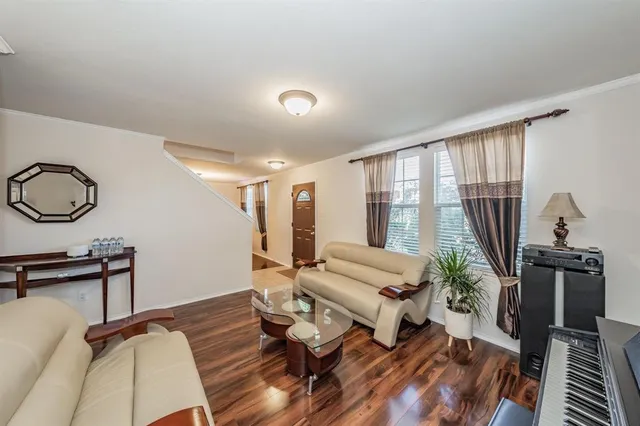 a living room with furniture a rug and a floor to ceiling window
