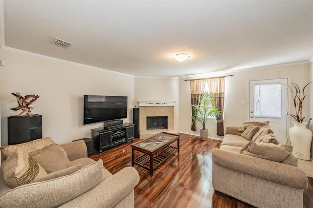a living room with furniture a fireplace and a flat screen tv