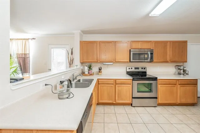 a kitchen with stainless steel appliances granite countertop a sink and dishwasher a stove top oven with wooden floor