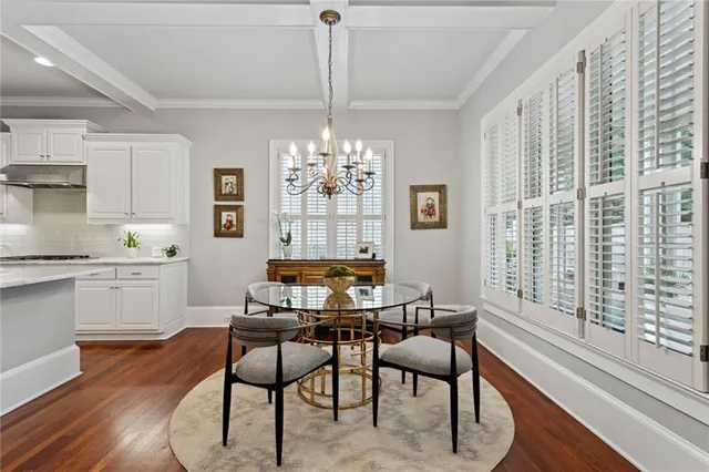 a dining room with furniture a chandelier and wooden floor