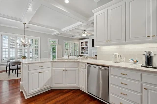 a kitchen with granite countertop white cabinets and white appliances