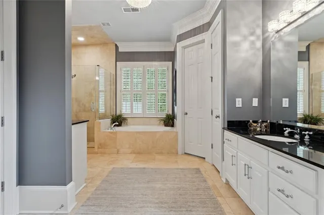 a spacious bathroom with a granite countertop tub sink and mirror